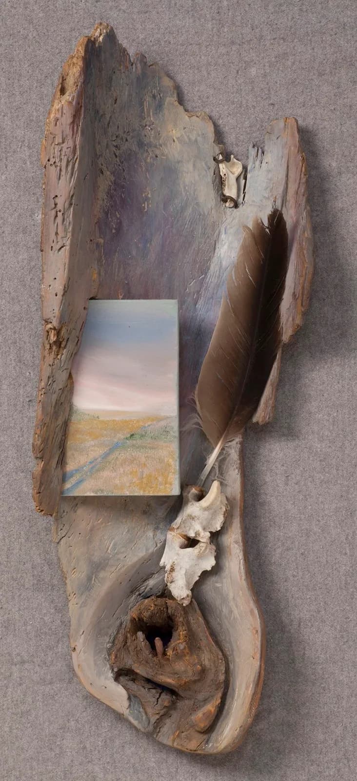 Driftwood mixed-media assemblage with a painted landscape panel framed by weathered wood and natural elements.